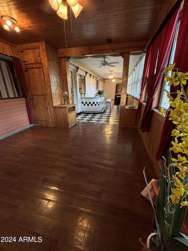hall featuring wood walls, wood ceiling, and wood finished floors