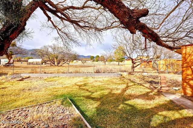 view of yard with a mountain view and fence