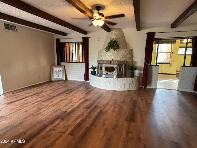 unfurnished living room with a fireplace, ceiling fan, wood finished floors, and a textured ceiling