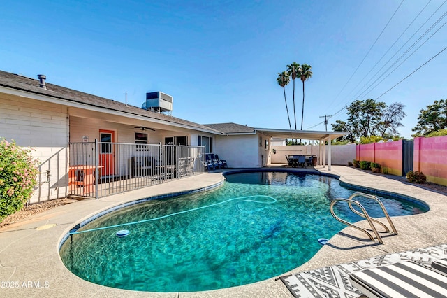 view of swimming pool with a fenced in pool, a patio, central AC unit, a ceiling fan, and a fenced backyard