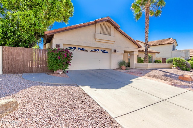 6122 E Saddleback St, Mesa, AZ 85215 - view of front of house with a tile roof, fence, concrete driveway, an attached garage, and stucco siding