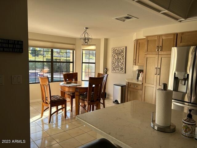 6122 E Saddleback St, Mesa, AZ 85215 - dining area featuring a chandelier, baseboards, visible vents, and light tile patterned floors