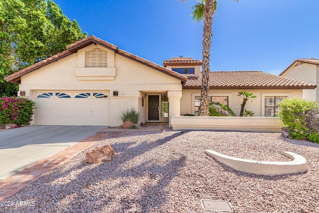 6122 E Saddleback St, Mesa, AZ 85215 - mediterranean / spanish-style house with a garage, stucco siding, a tiled roof, and driveway
