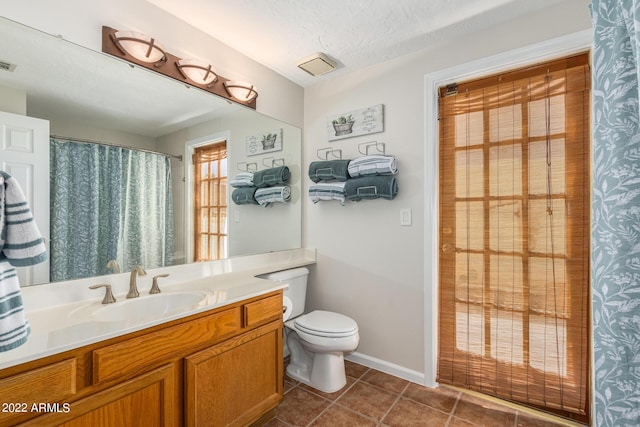 6122 E Saddleback St, Mesa, AZ 85215 - bathroom with tile patterned flooring, visible vents, vanity, toilet, and a textured ceiling