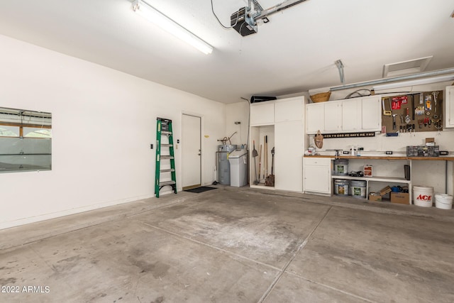 6122 E Saddleback St, Mesa, AZ 85215 - garage with a garage door opener, water heater, and a workshop area