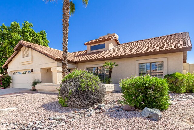 6122 E Saddleback St, Mesa, AZ 85215 - mediterranean / spanish home featuring an attached garage, stucco siding, a tile roof, and concrete driveway