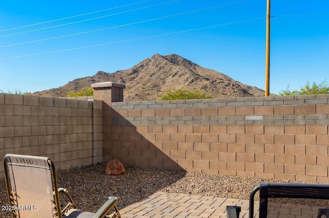 view of yard featuring a mountain view and fence