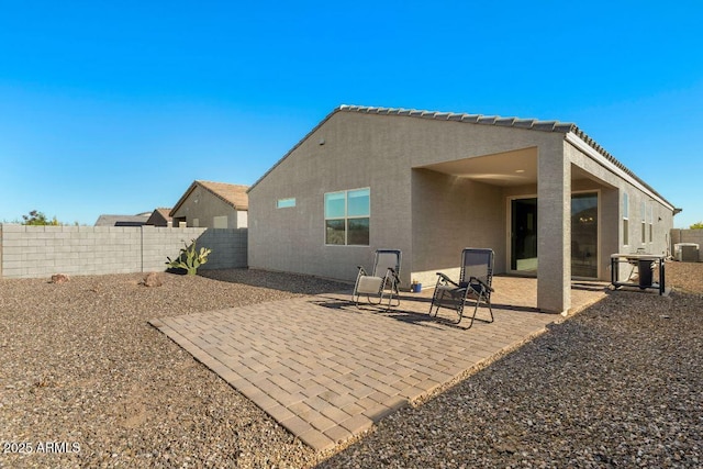 back of property featuring a patio, a fenced backyard, and stucco siding