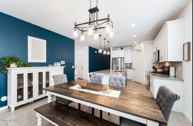 dining room featuring recessed lighting and a chandelier