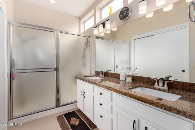 bathroom featuring walk in shower and vanity