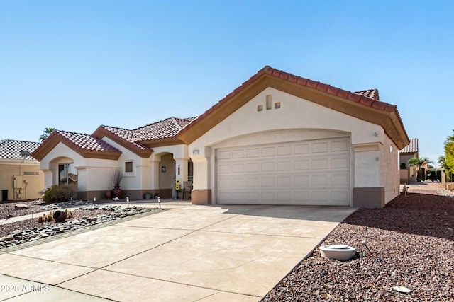 mediterranean / spanish house featuring a garage