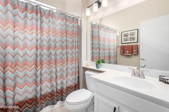 bathroom with vanity, toilet, and a shower with shower curtain