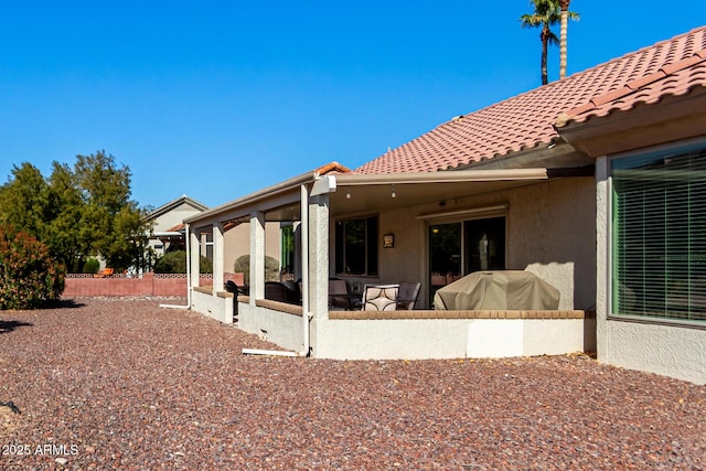 back of house with a sunroom and a patio