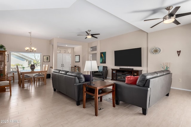 living room with light hardwood / wood-style floors and ceiling fan with notable chandelier