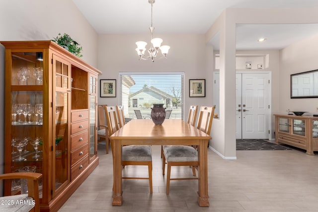 dining area featuring an inviting chandelier and hardwood / wood-style flooring