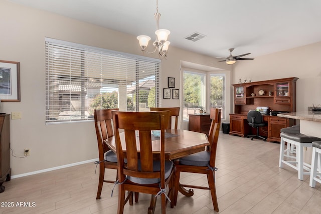 dining space featuring ceiling fan with notable chandelier and light wood-type flooring