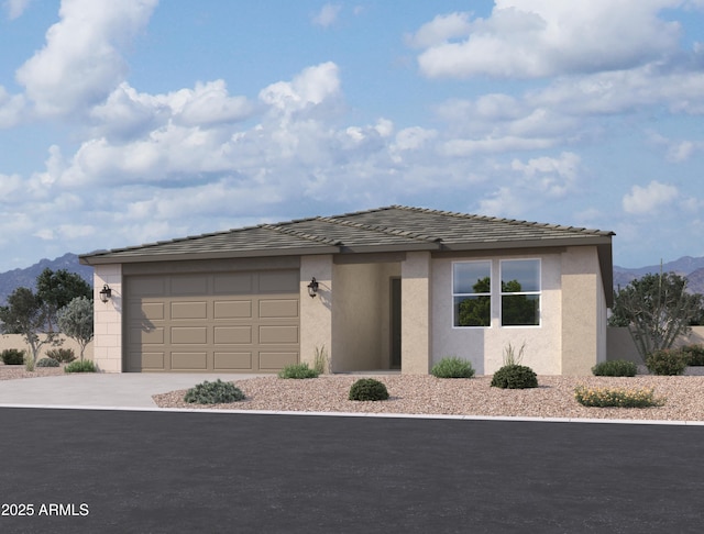 view of front of home with a garage, stucco siding, driveway, and a mountain view