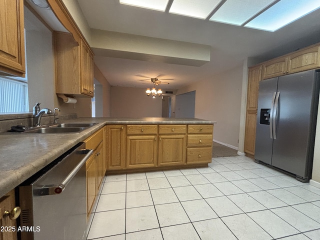 kitchen featuring ceiling fan, kitchen peninsula, sink, appliances with stainless steel finishes, and light tile patterned floors