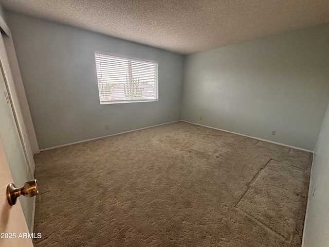 carpeted spare room with a textured ceiling