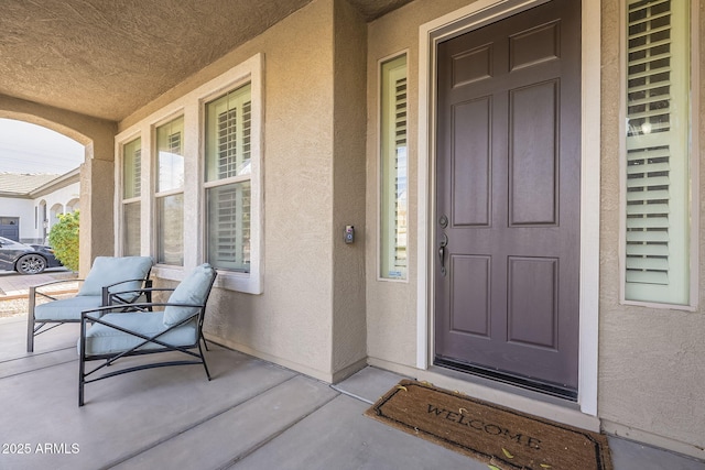 view of exterior entry with covered porch