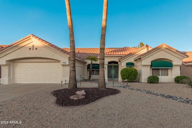 mediterranean / spanish-style house with a garage