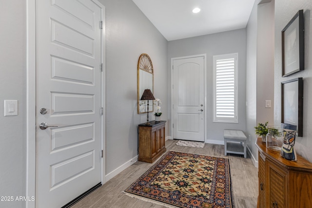 entryway featuring baseboards and light wood-style floors