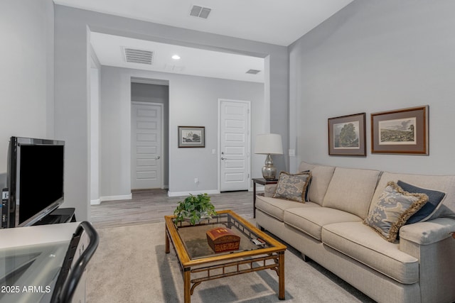 living area featuring visible vents, recessed lighting, baseboards, and wood finished floors