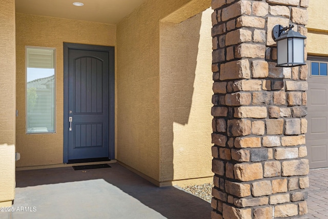 property entrance featuring stucco siding