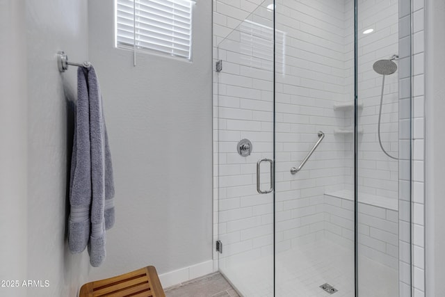 full bath with baseboards and a stall shower