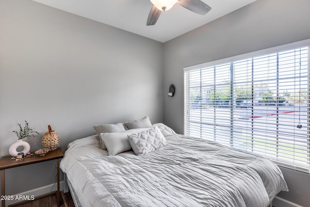 bedroom with a ceiling fan and baseboards