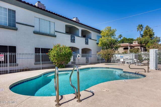 pool featuring a patio and fence