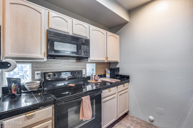 kitchen featuring dark countertops, decorative backsplash, black appliances, and light tile patterned floors