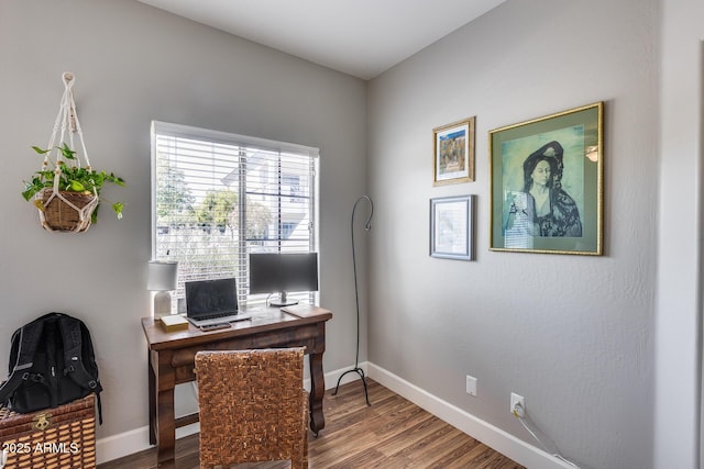 office area with baseboards and wood finished floors