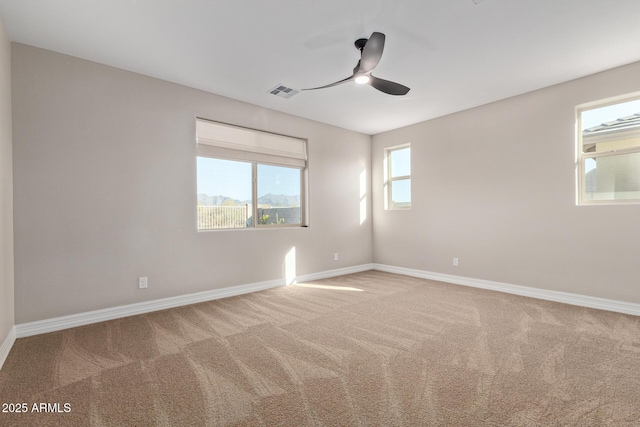 carpeted empty room featuring ceiling fan