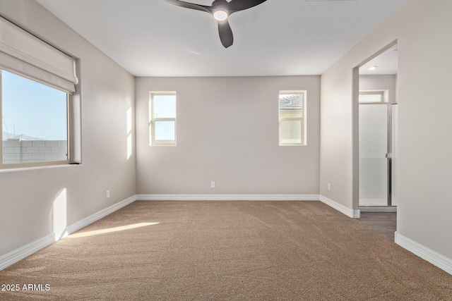 carpeted empty room featuring ceiling fan