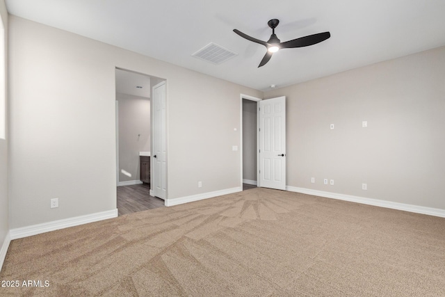 unfurnished bedroom featuring ceiling fan, carpet flooring, and ensuite bath