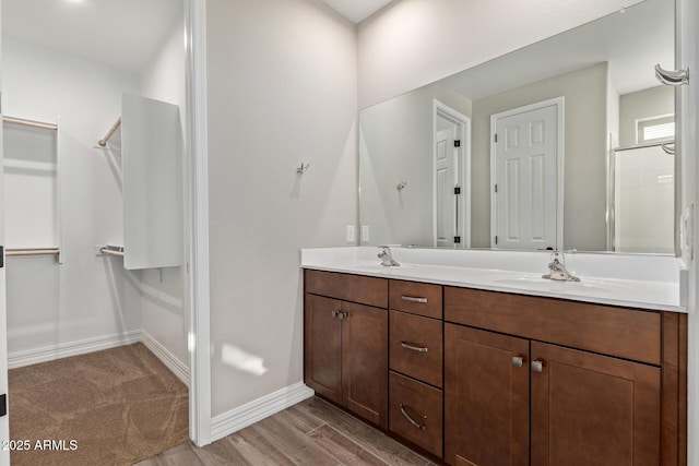 bathroom with vanity, hardwood / wood-style floors, and an enclosed shower