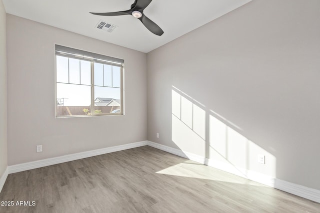 empty room featuring ceiling fan and light hardwood / wood-style flooring