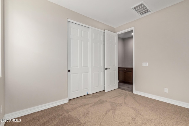 unfurnished bedroom with a closet and carpet flooring