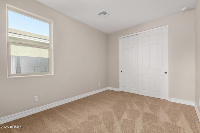 unfurnished bedroom with a closet and carpet