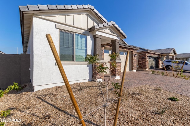 view of side of home featuring a garage