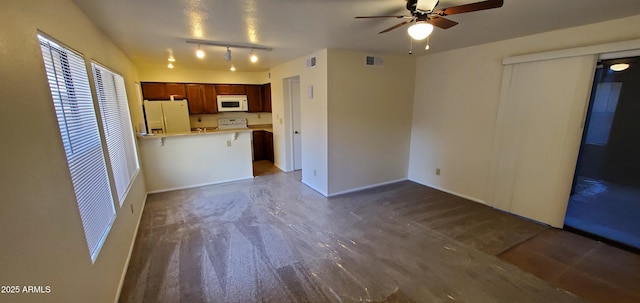 kitchen with ceiling fan, white appliances, and kitchen peninsula