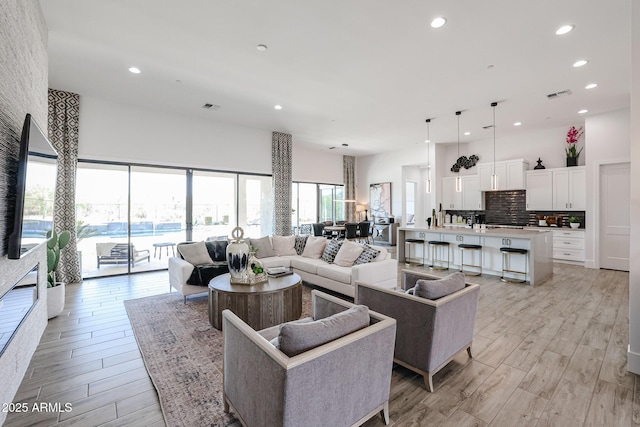 1920 E Creek Canyon Rd, Phoenix, AZ 85086 - living room featuring light wood-type flooring, recessed lighting, and a high ceiling