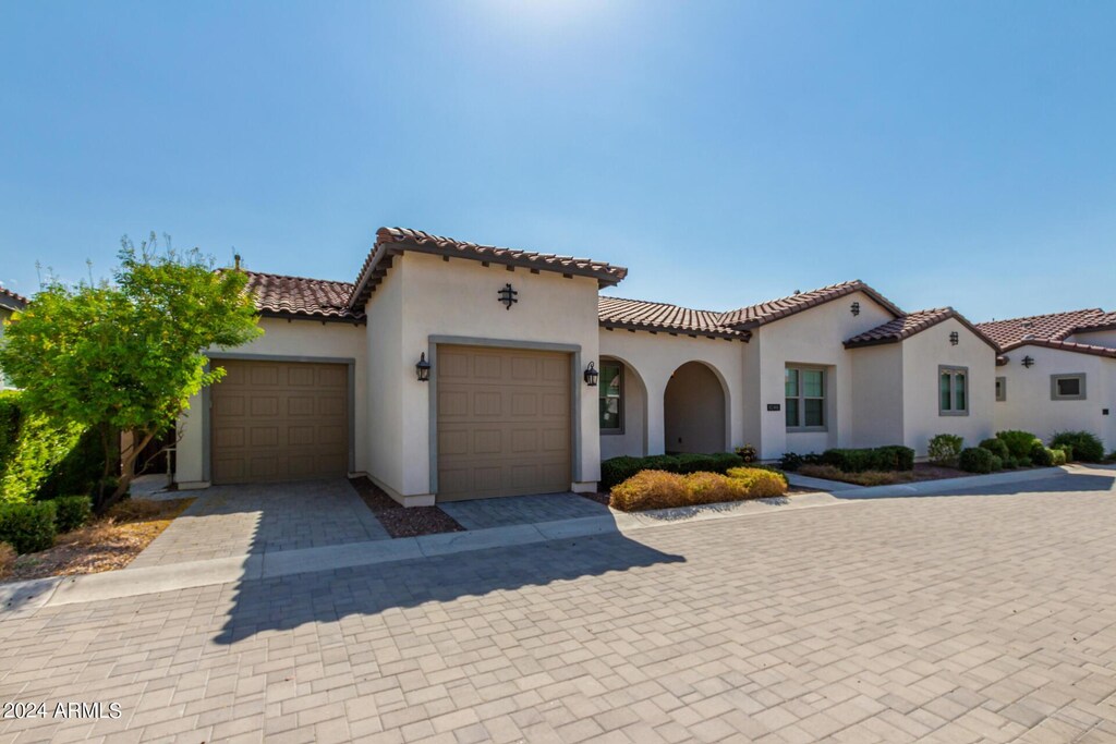 mediterranean / spanish-style house with a garage