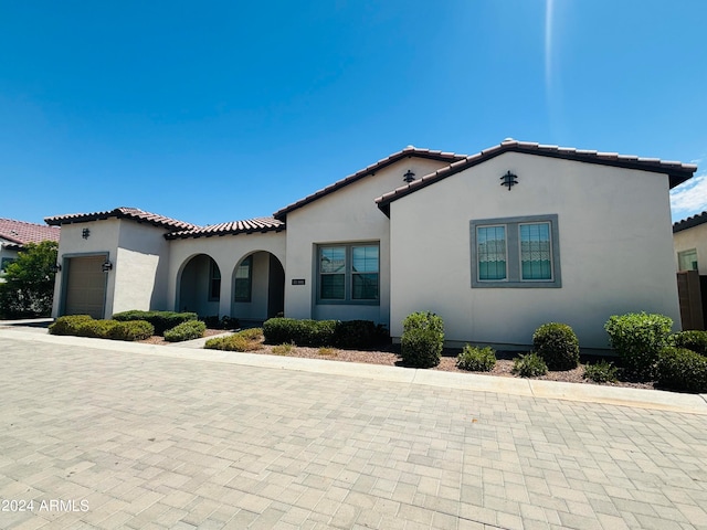 mediterranean / spanish house featuring a garage