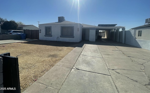 view of front of property featuring a carport and central air condition unit