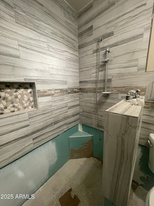 bathroom with a tile shower