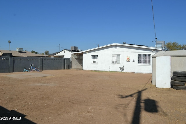 rear view of property featuring central AC