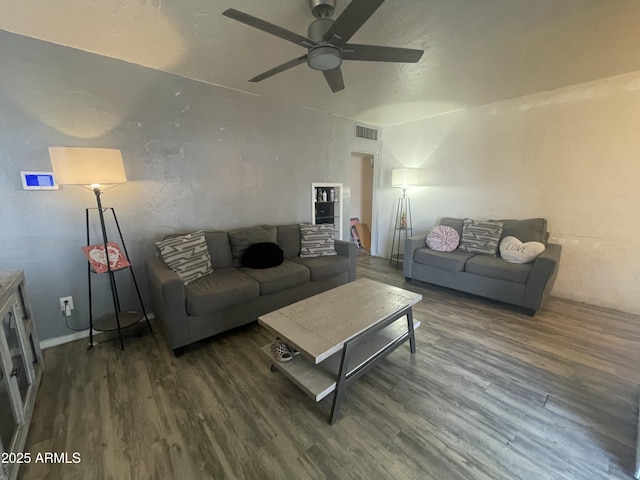 living room featuring ceiling fan and dark hardwood / wood-style flooring