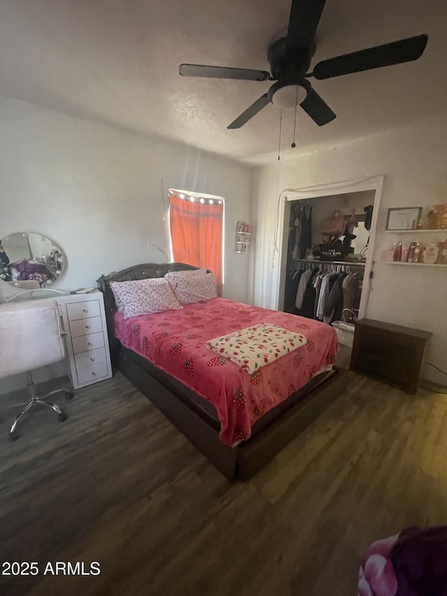 bedroom featuring a closet, dark hardwood / wood-style floors, and ceiling fan